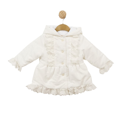 Discover this girls white lightweight hooded coat by Mintini Baby. Crafted from a delicate white material, this coat offers lightweight comfort, ideal for your young one. With frill detailing on the front, back, cuffs, and bottom, this coat combines practicality and elegance. Sizes range from 3 months to 5 years. Also available in pink.