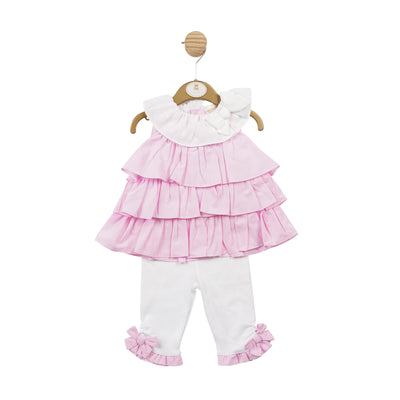 This Mintini Baby girls' tunic and legging set is perfect for spring and summer. The soft pink and white gingham pattern is both adorable and stylish, making your little one stand out. The top is ruffled with a white collar and bow detail, and the leggings are in white with pink frill and bow detail around the ankle. With sizes from 3 months up to 5 years old, this set is ideal for matching sisters and can be worn for any occasion.