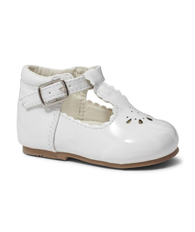 As a leading brand in children's footwear, Sevva presents these beautiful girls white patent T-Bar shoes with an elegant cut out pattern design. These hard sole shoes provide support and comfort for growing feet, while the buckle fastening ensures a secure fit. Available in infant sizes 2 up to 6.