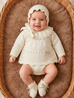 mac ilusion baby girl natural knitted frill collar top jam pants bonnet booties 4 piece set lifestyle view in wicker basket