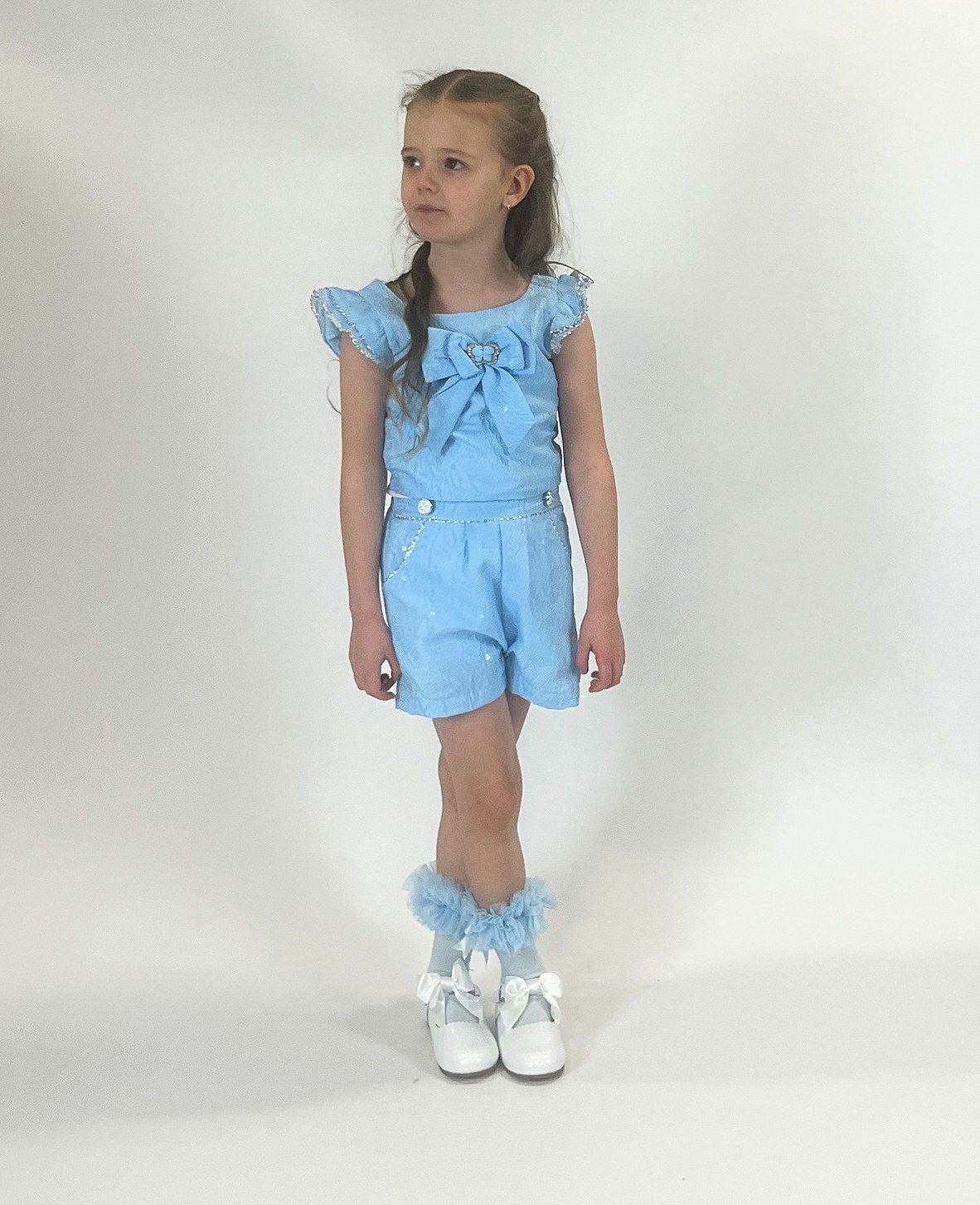 This new arrival from Beau Kid is perfect for your young fashionista. This two piece set features a vibrant blue top with a large bow and matching shorts. From the stylish spring/summer collection, it comes in sizes 2-3 year old up to 9-10 year old.