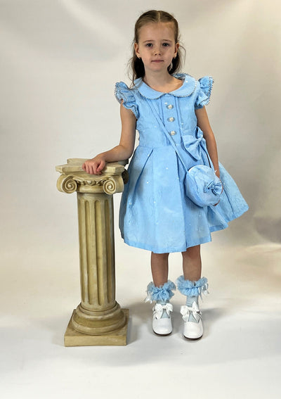 Expertly designed for your little fashionista, the Beau Kid girls blue dress is a must-have for any spring/summer wardrobe. Featuring a delicate small collar and charming bow accents, this short sleeve dress is both stylish and comfortable. Complete the look with the matching mini handbag. Available in sizes 1-2 years old up to 7-8 years old.