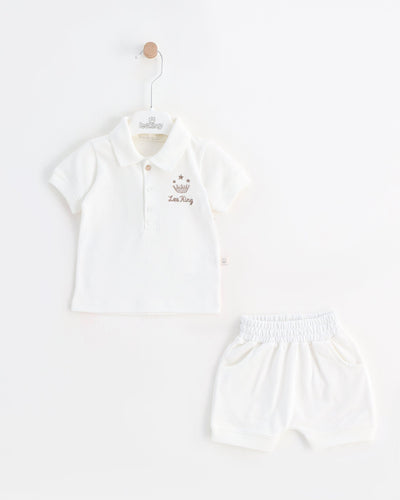 <p>Prepare your child for the upcoming warmer months with our Leo King boys' white short set. Ideal for spring and summer, this set features a collared top with three button fastening and elasticated waistband shorts in white. The top has the Leo King logo to one side. Sizes range from 3-6 months to 12-18 months for your convenience.</p>