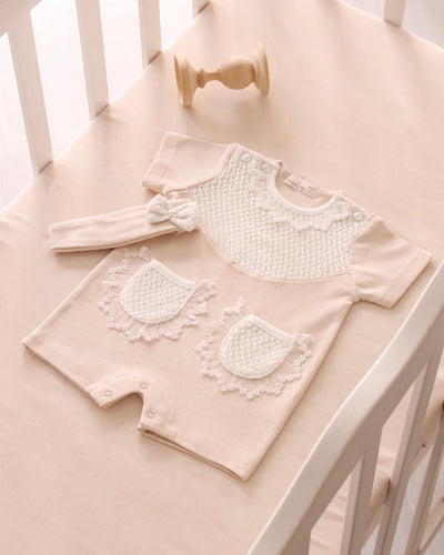 <p>Experience the luxury of this Leo King branded baby girls beige romper set. Crafted from high-quality cotton, this onesie boasts a delicate collar, convenient back and leg button closures, and includes a coordinating headband. Choose from 1-3m, 3-6m, 6-9m, and 9-12m sizes to ensure your little girl stays chic and cosy.</p>