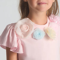 Close-up of the Beau Kid girls t-shirt highlighting the intricate 3D fabric flowers, beadwork, and vibrant botanical print of the coordinated skirt.