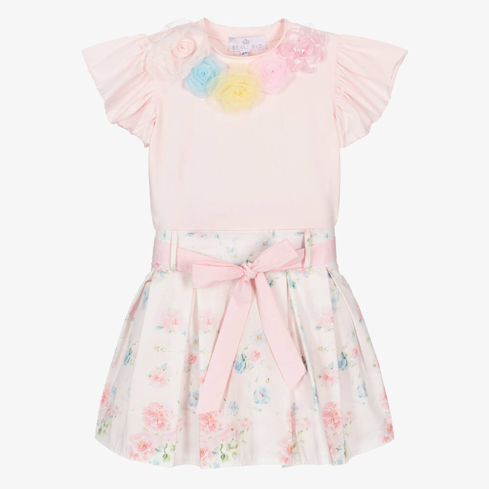 Front view of the Beau Kid girls ivory and pink rose print dress, featuring a smocked bodice, lace-trimmed ruffles, and a full-skirted boutique silhouette.