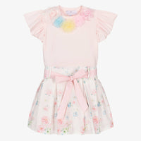 Front view of the Beau Kid girls ivory and pink rose print dress, featuring a smocked bodice, lace-trimmed ruffles, and a full-skirted boutique silhouette.
