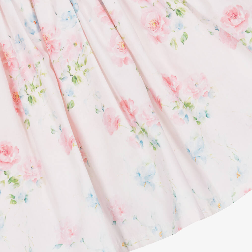 Close-up of the Beau Kid dress showcasing the intricate smocking and vibrant pink rose graphic on lightweight cotton poplin.