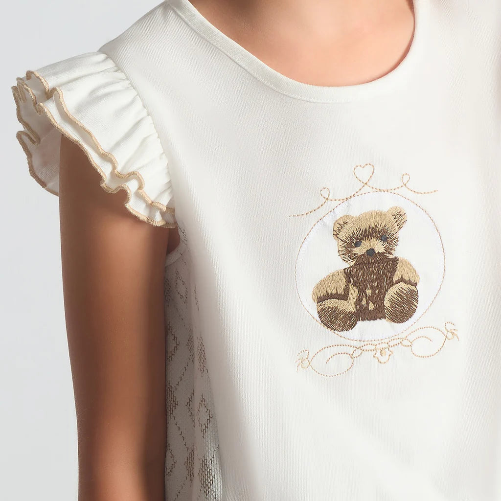 A close-up image of the Beau Kid camel jersey top highlighting the teddy bear motif and the 3D fabric bow embellishment.