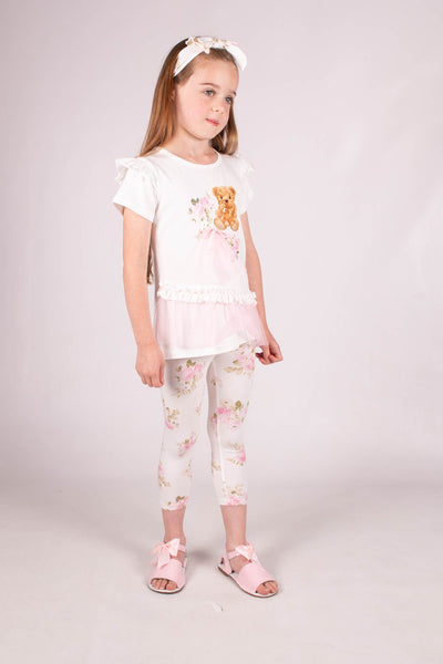   Experience the perfect combination of comfort and fashion with this girls ivory & pink teddy detail legging set by Beau KiD. Crafted from a luxurious cotton jersey, this set showcases a short-sleeved T-shirt adorned with an adorable teddy and floral design, enhanced by delicate ruffled edges and pink stitching. The leggings, featuring a dainty floral pattern, effortlessly tie the whole outfit together with a delightful touch.