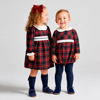 rapife boys navy tartan romper standing beside girls matching dress model