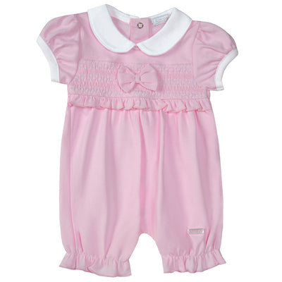 <p data-mce-fragment="1">Introducing our Amore branded girls pink smocked romper with bow detail. This delightful romper features a charming smocked design, perfect for the spring summer collection. The white collars and cuffs add a touch of elegance while the elasticated legs ensure a comfortable fit. Available in sizes 0-3 months up to 18-24 months.</p>