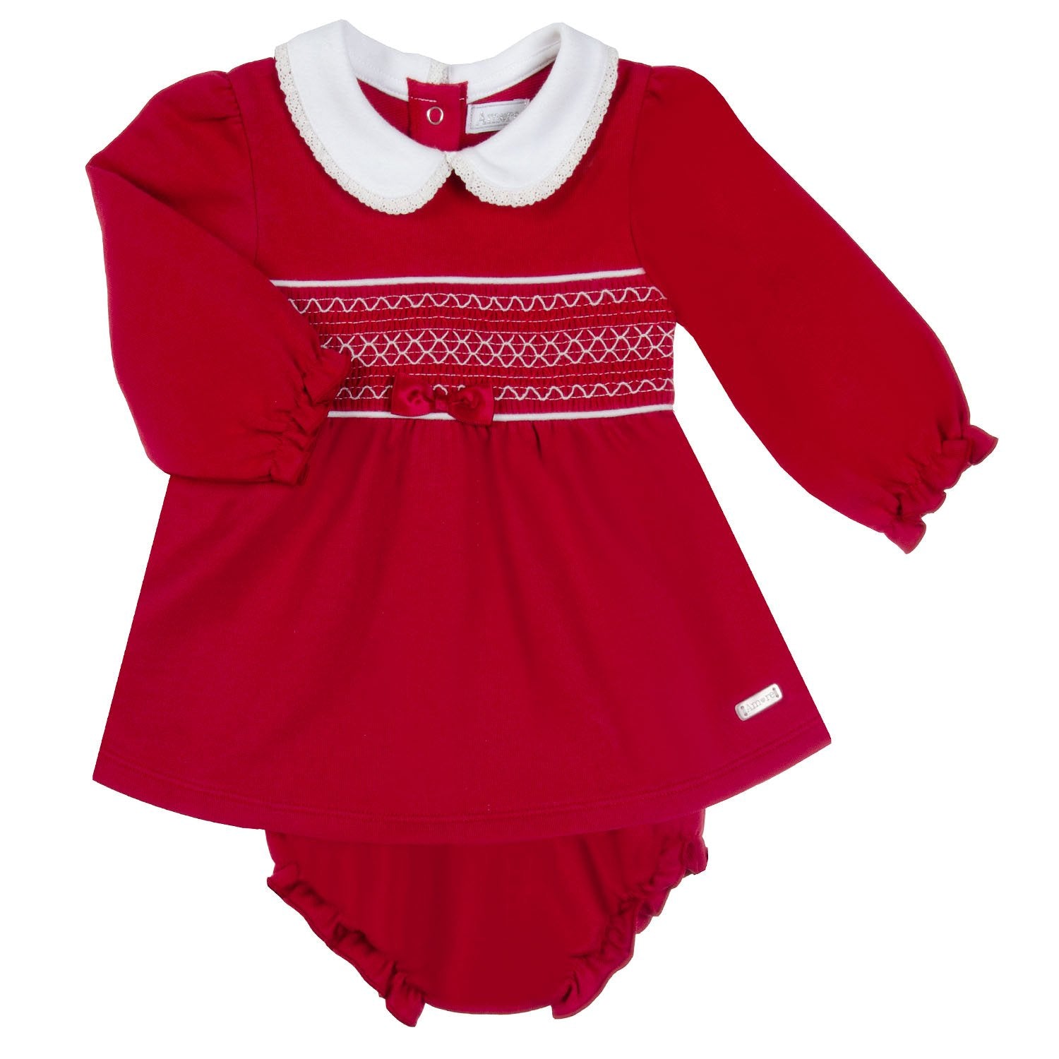 Introducing our new arrival from our Amore branded autumn winter collection - the girls red smocked dress with pants. This dress features a stylish smocked detail and a small satin ribbon bow for added charm. The elasticated pants provide maximum comfort and the white collars add a touch of elegance. Available in sizes 0-3 months up to 18-24 months.