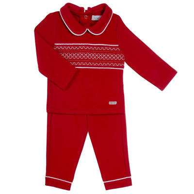 Introducing Amore's red two piece smocked top &amp; trouser set for baby boys. This set features long sleeves, peter pan style collars, and button fastening on the reverse. The classic smocked design adds a touch of elegance, perfect for any Christmas occasion. Available in sizes 0-3 months up to 18-24 months.