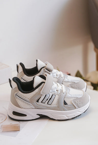 Introducing our new arrival from our spring summer footwear collection - this unisex grey, white and black chunky sole fashion trainer. With a stylish N design on the side, these shoes feature a velcro and shoe lace fastening and is suitable for both boys and girls, available in infant size 3 up to a junior size 3.