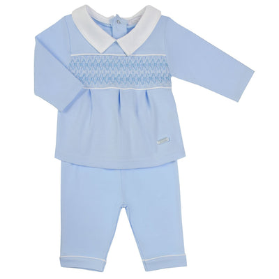 Introducing our new season arrival, boys blue two piece smocked set by Amore. This stylish outfit for boys features a smock design with white collars, paired with comfortable long sleeve top and matching trousers. Available in sizes 0-3 months up to 18-24 months. This classic design is perfect for any occasion!