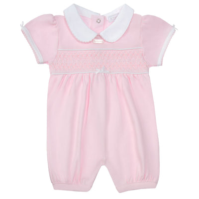 Introducing our new arrival for girls - the girls pink short sleeve smocked romper! This romper features a delicate pink colour, short sleeves, and a smocked design. It also has small bow details on the arms and in the middle, and a white collar for added charm. Available in sizes 0-3 months up to 18-24 months, this romper is a perfect addition to your little one's wardrobe.