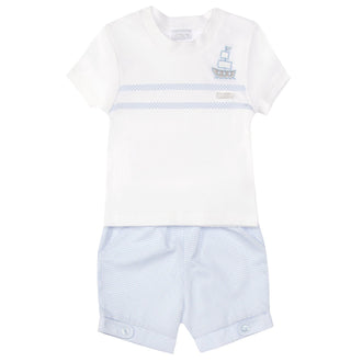 This two-piece set by Amore features a white round neck t-shirt with a ship motif on the side and two blue stripes across the chest, paired with matching blue shorts. Perfect for little boys, sizes 0-3 months up to 18-24 months. Add a touch of style to your child's wardrobe with this nautical-inspired look.