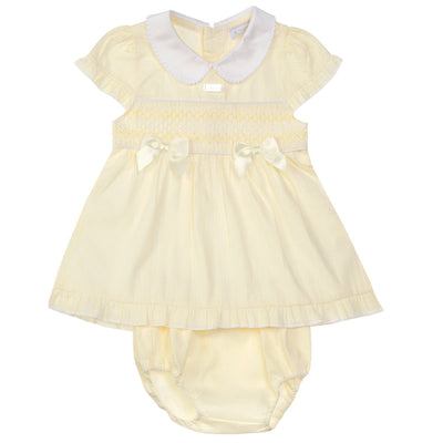 This girls lemon smocked dress with pants from childrenswear boutique brand Amore is the perfect spring and summer outfit or Easter ensemble for your little girl. The smocked design, lemon bows, and white collar add a touch of charm, while the matching pants ensure comfort and convenience. Available in a range of sizes from 0-3 months up to 18-24 months.