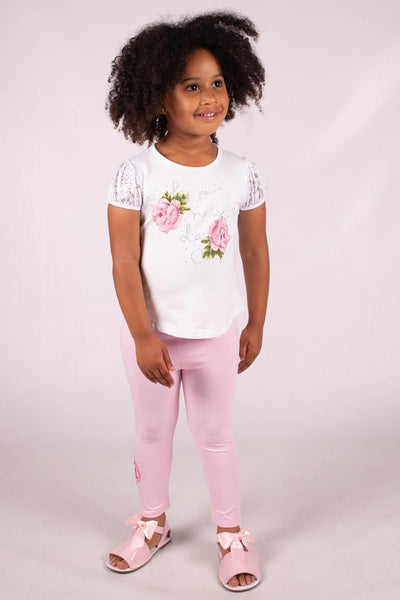 Introducing our new girls white & pink two piece top and legging Set, perfect for spring and summer! This adorable two piece set features a white top with pink floral detail and pink leggings with floral embellishments on the leg. Available in sizes 2/3 years to 6/7 years. Update your little one's wardrobe now!