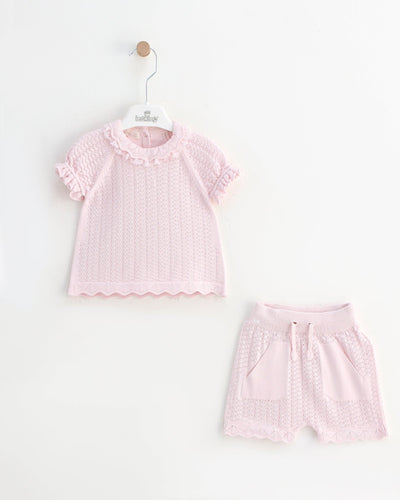 <p>Introducing our Leo King girls' pink knitted two-piece top and shorts set from the Spring Summer Collection. Crafted from top-quality knit fabric, this set offers both comfort and style. The beautifully detailed lace collar adds a touch of elegance to the design. Choose from sizes 3-6 months to 12-18 months.</p>