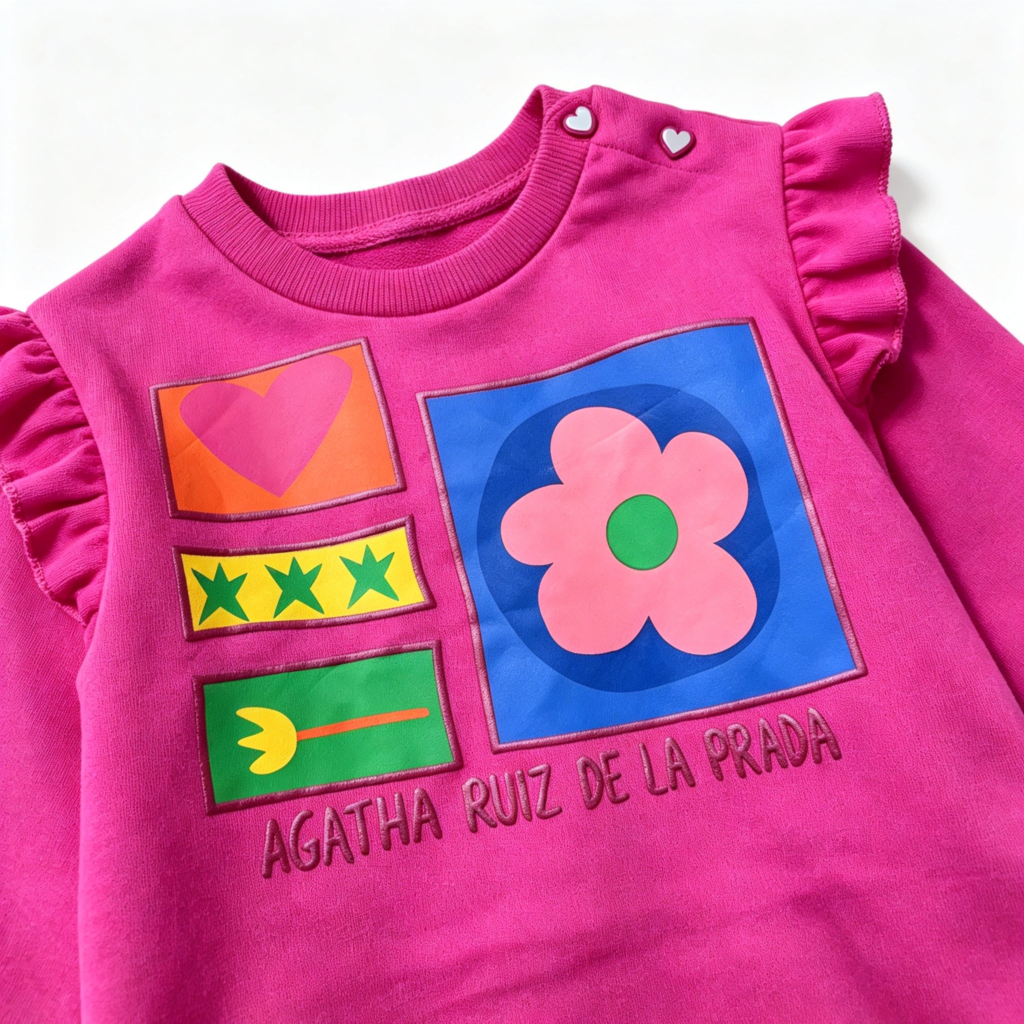 close up view of agatha ruiz de la prada graphic chest print on fuchsia sweatshirt