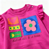 close up view of agatha ruiz de la prada graphic chest print on fuchsia sweatshirt
