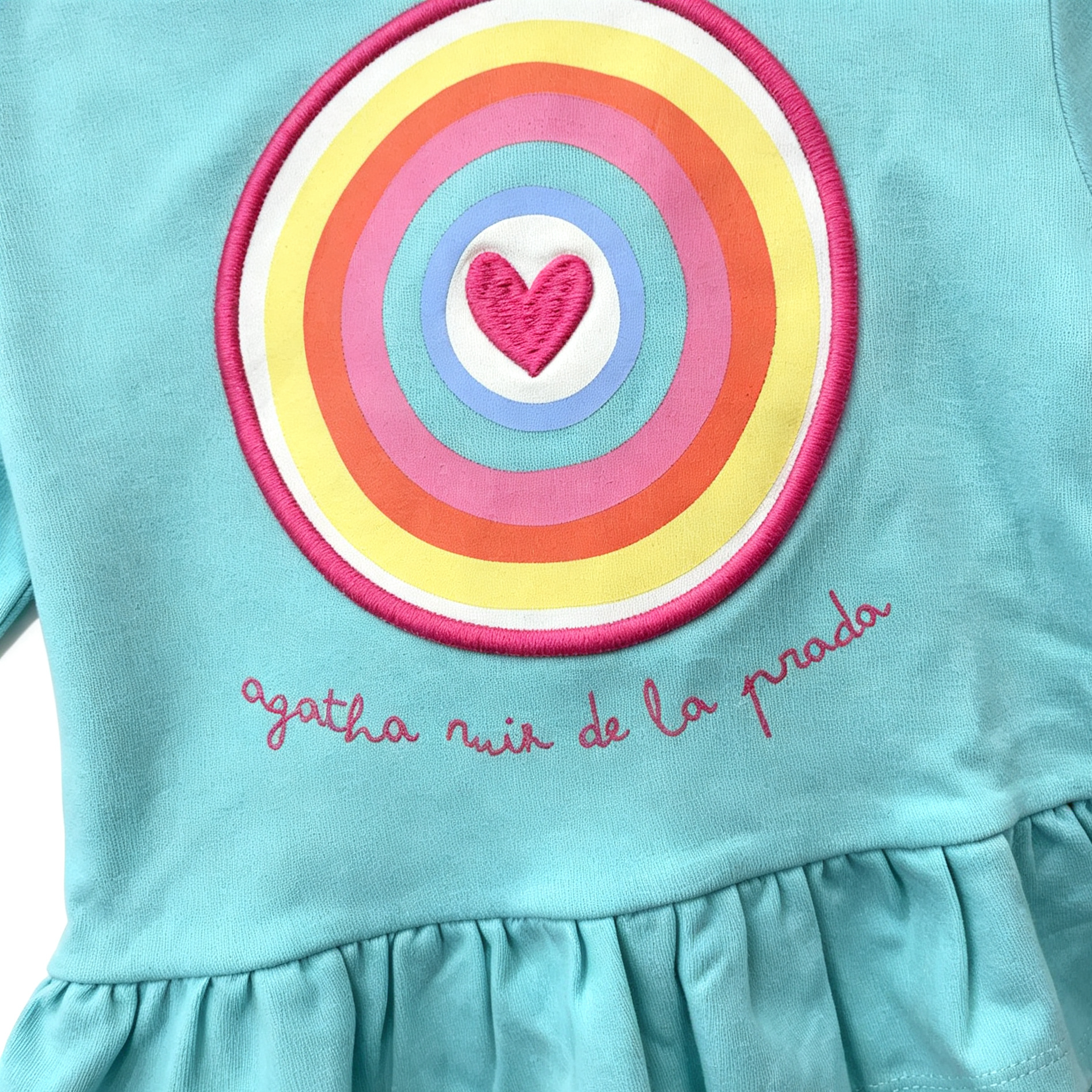 close up of agatha ruiz de la prada rainbow target embroidery on turquoise hoodie
