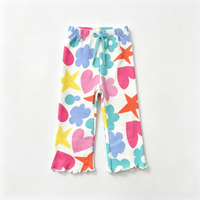 girls white leggings with all over colorful heart and flower print flat lay