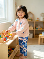 toddler playing indoors with wooden blocks wearing agatha ruiz de la prada pink quilted sweatshirt set