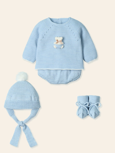 Introducing the newest addition to our autumn winter collection - the baby boys blue teddy detail four piece set from Spanish children's clothing brand, Mac Ilusion. Crafted with the utmost care, this set includes a pastel blue top with a cute teddy motif, culotte shorts, a matching bobble hat, and booties, all presented in a gift box. Available in sizes 1 month, 3 months, and 6 months.