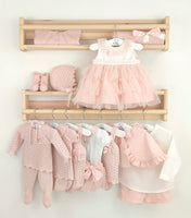 Flat lay of nude baby outfit with bonnet, booties, culotte, and top by Spanish brand Mac Ilusion