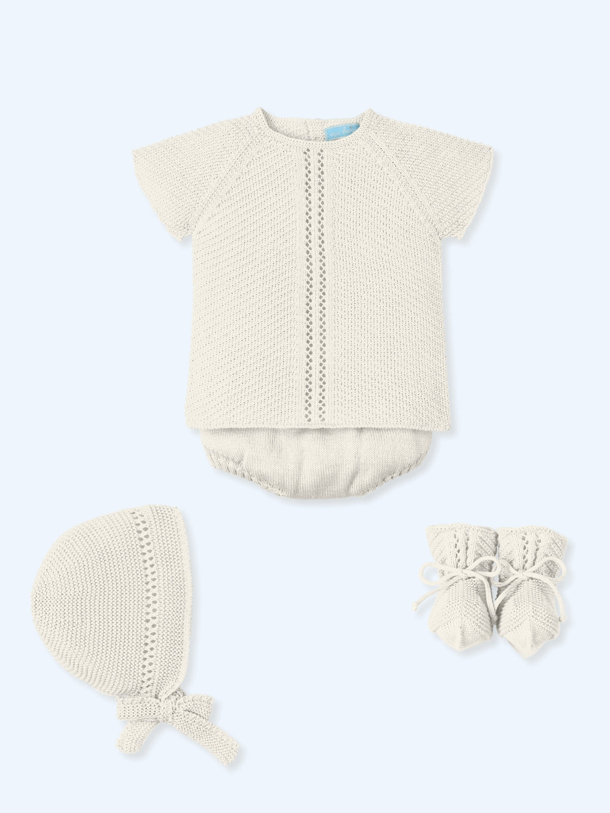 Baby boy four-piece knitted outfit in cream with short-sleeved top, shorts, bonnet, and booties from Mac Ilusion Spring Summer collection.