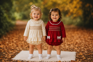 amore girls red smocked jam pant set models standing together in autumn leaves boutique childrenswear