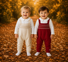 amore boys red smocked dungaree set models standing together in autumn leaves boutique childrenswear