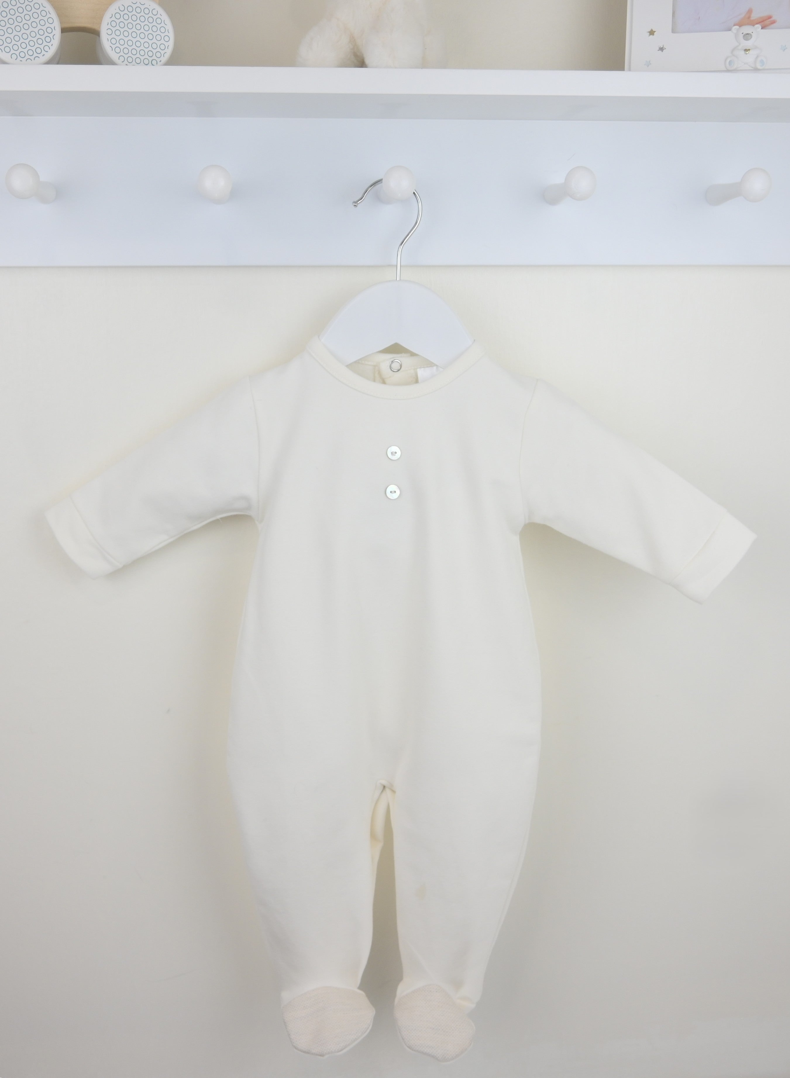 Traditional baby boys ivory long sleeved cotton sleepsuit by Pex with integrated feet for a boutique style finish