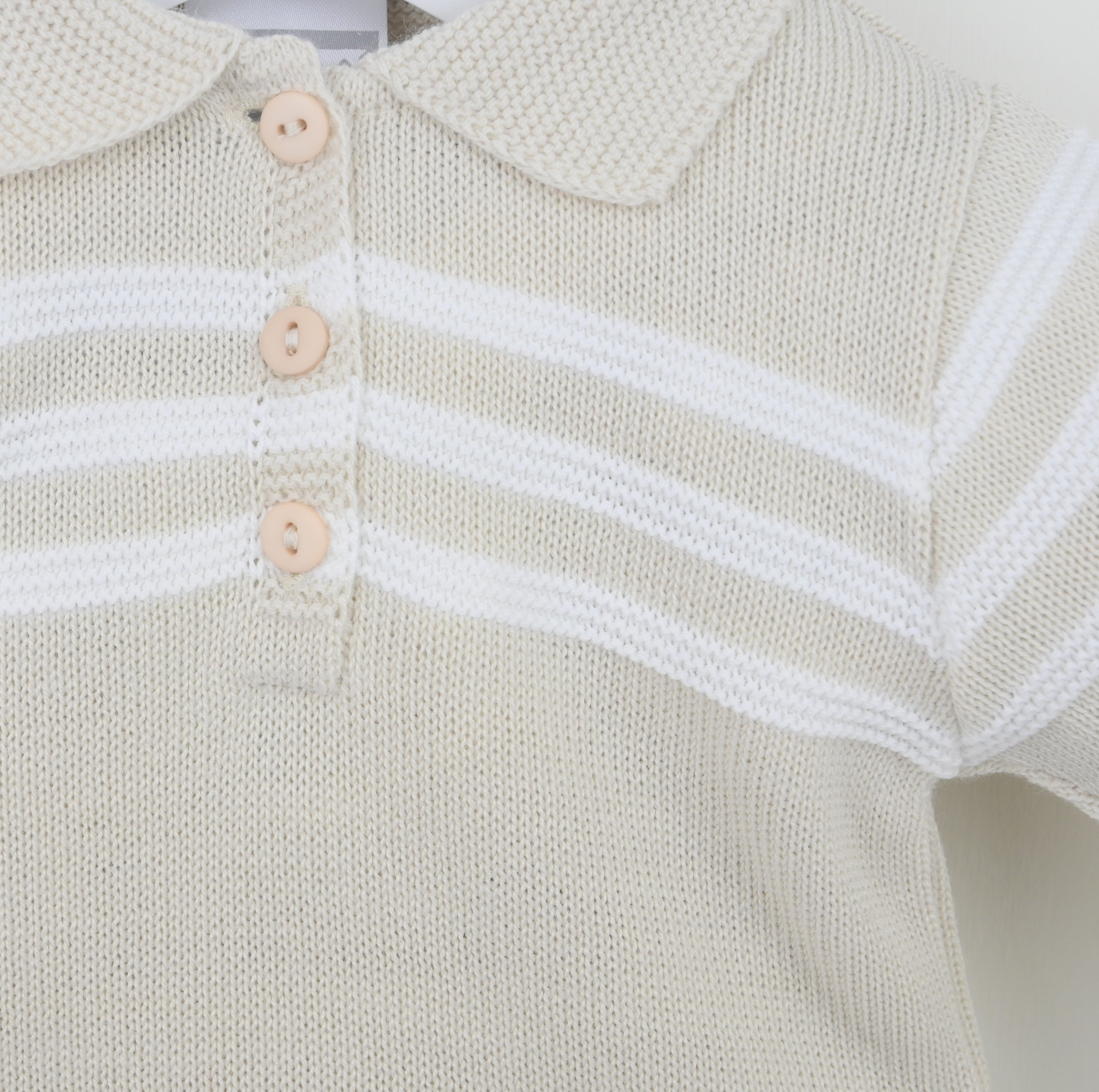 Close up of Pex Mateo boys natural knitted polo shirt showing white stripe detail and button placket