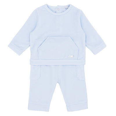 Blue Baby branded boys two piece top and trouser set finished in a pastel baby blue colour. The top has a round neck collar with push button opening at the rear, at the front there is a pocket in the middle. The trousers have a elasticated waistband with pockets on the sides. Available in sizes 3 month up to 24 month.