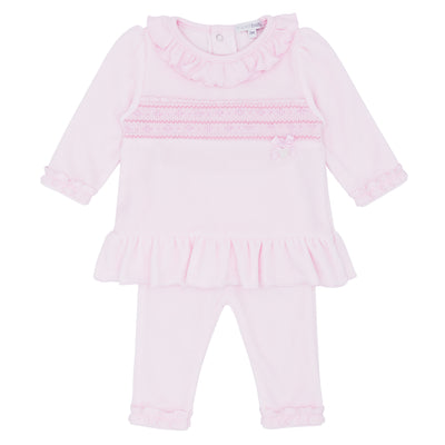Blues Baby branded girls tunic and legging set finished in a pastel pink colour. The tunic is finished in a soft velour fabric, it has a smocked design going through the middle and a frilled round neck collar. It comes with leggings to match which have a frilled design around the ankle. Available in sizes 3 month up to 24 month.