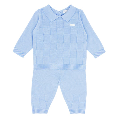Blues Baby branded boys two piece square knitted set finished in a pastel blue colour. The top has collar detail with button fastening, and the trousers have a elasticated waistband. Available in sizes 3 month up to 24 month.