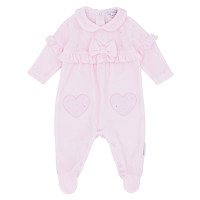 Blues Baby branded girls velour sleepsuit finished in a pastel pink colour. This sleeper has beautiful bow with stud detail to the front, and frill around the arms and going through the middle. Available in sizes 1 month and 3 month.