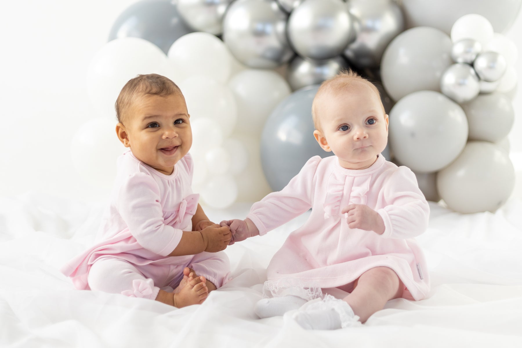 Blues Baby branded baby girls two piece top and legging set finished in a soft pastel pink colour. This set consists of a round neck tunic top with long sleeves, it has a diamanté bow detail to the middle and on the ankles on the leggings. Available in sizes 3 month up to 12 month.