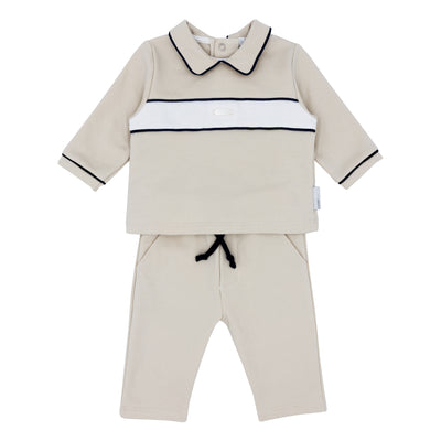 Elevate your little one's wardrobe with our boys beige &amp; navy two piece jogger set. This Blues Baby branded tracksuit, from our autumn winter collection, features a classic top design with a white band going across and navy piping, and comes with matching beige joggers. This boys outfit is available in sizes ranging from 3 months to 4 years, making it the perfect coordinated outfit for brothers. Shop now and elevate their style game!