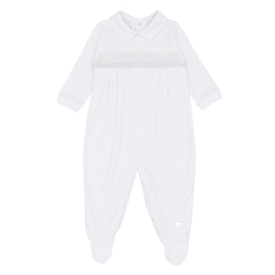 This boys all in one sleeper is designed for newborns and babies up to 3 months old. The soft white and grey colour scheme is accented by a smocked band on the chest and a push button closure on the back. Featuring long sleeves and collars, this sleeper is branded by Blues Baby to ensure quality.