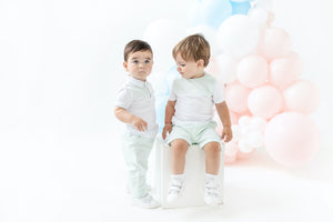 Experience unmatched style and comfort with this polo shirt and trouser set for boys by childrenswear brand Blues Baby. The unique mint green box design on the short-sleeved polo shirt is complemented by a button fastening collar, while the mint green trousers feature white piping detail and an elasticated waistband for a touch of sophistication. Available in sizes for 3 months up to 4 year olds, this set is perfect for any occasion and ideal for matching siblings.