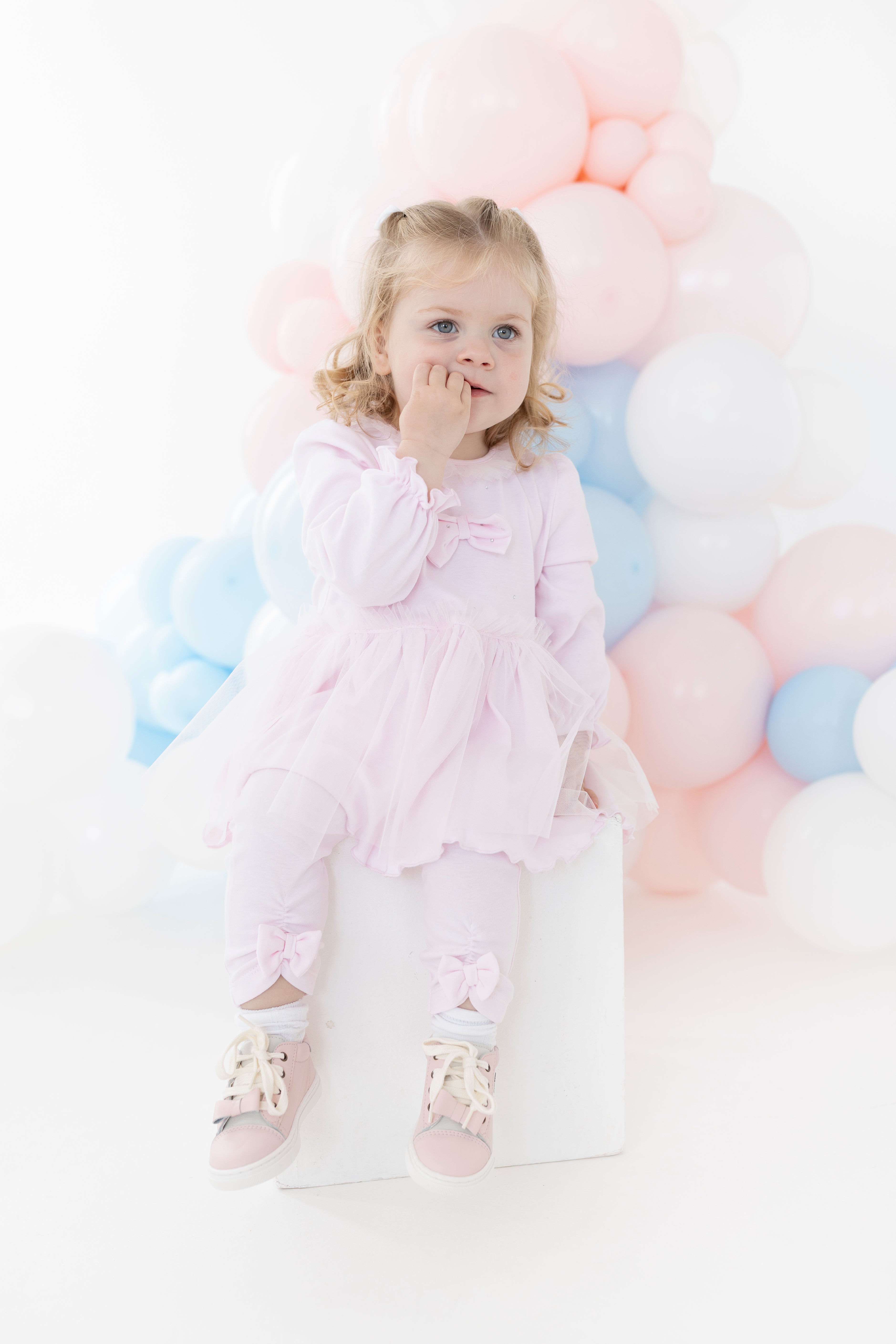 blues baby girls pink helsinki tutu dress and legging set sitting model heritage childrenswear luxury kids fashion