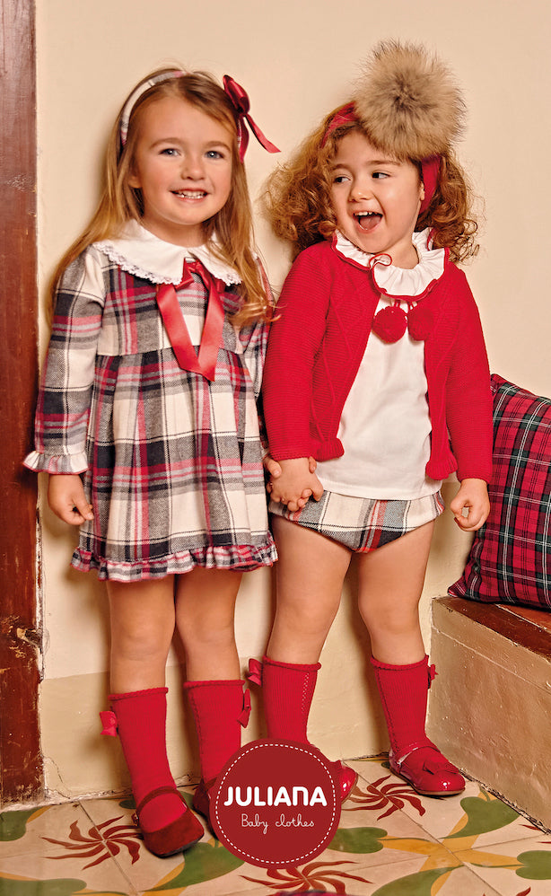 This girls red checked dress from Spanish childrenswear brand Juliana is perfect for your little one this winter! It boasts a beautiful, on-trend checked print and a classic red bow for a timeless look. Available in sizes from 3 months up to 4 years, this dress will make a wonderful addition to her wardrobe.