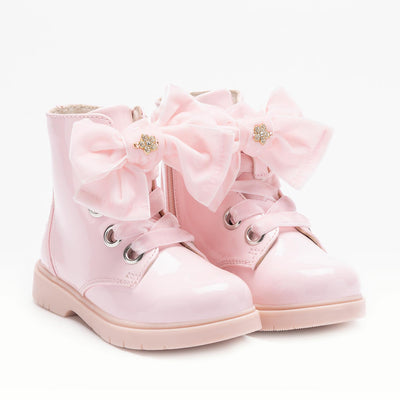 Girls pink patent Lelli Kelly LKHF5330 boots with large bow, chunky sole, and zip fastening – boutique kids’ footwear