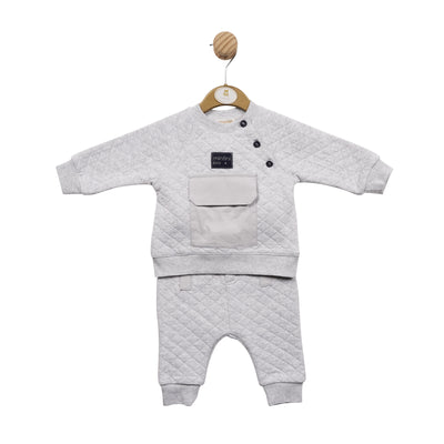 This stylish two piece grey sweatshirt & jogger set by Mintini Baby is the perfect clothing set for boys. The sweatshirt has navy blue three button detail and a pocket, whilst the matching joggers feature an elasticated waistband for a comfortable fit. This set is available in sizes 3 month up to 24 month.