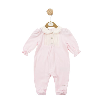 Expertly crafted by Mintini Baby, this pink smocked all in one sleepsuit is a must-have for your little one. The delicate pastel pink hue and charming smocked design add a touch of sweetness, while the frilly collar detail adds a playful touch. Available in sizes 1 month to 6 months for a perfect fit.